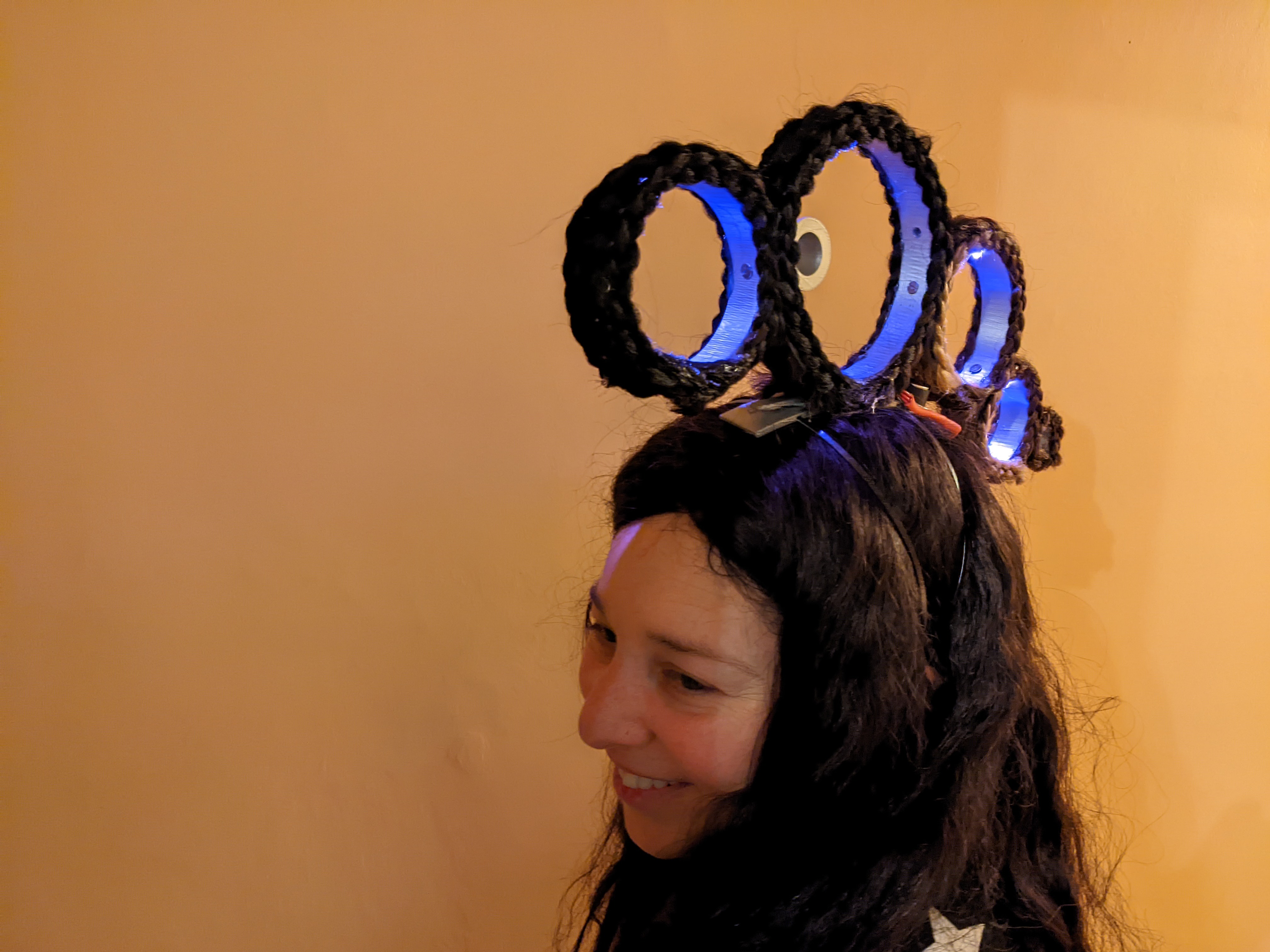 person wearing four hoops with braided hair on top of their head